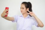 Portrait Of Thai High School Student Uniform Beautiful Girl Using Her Smart Phone Selfie Stock Photo