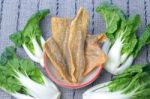 Crispy Fried Salmon Skin And Canton Pak Choi Stock Photo