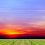 Soccer Field With Beautiful Sunset Background Stock Photo