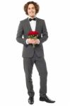 Groom In Tuxedo Posing With A Bouquet Stock Photo