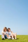 loving friends sitting in lawn Stock Photo