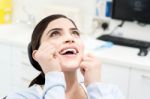 Female Cleaning Her Teeth With  Dental Floss Stock Photo