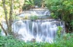 The Water Flowing Over Rocks And Trees Down A Waterfall At Huay Mae Khamin Waterfall National Park ,kanchana Buri In Thailand Stock Photo