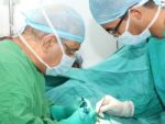 Surgeons Working On A Patient In Operation Room Stock Photo