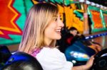 Beautiful Girl In An Electric Bumper Car At Amusement Park Stock Photo