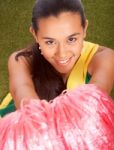 Smiling Cheerleader With Her Pom Poms Stock Photo