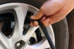 Inflating The Automobile Wheels Via A Pump Stock Photo