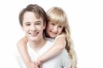 Young Boy Giving Little Girl Piggyback Ride Stock Photo