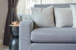 Modern Grey Sofa With Pillows In Living Room Stock Photo