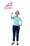 Senior Uk Supporter Waving National Flag Stock Photo