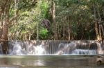 The Water Flowing Over Rocks And Trees Down A Waterfall At Huay Mae Khamin Waterfall National Park ,kanchana Buri In Thailand Stock Photo