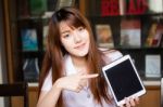 Portrait Of Thai Adult Student University Uniform Beautiful Girl Using Her Tablet Stock Photo