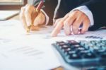 Businessman's Hands With Calculator At The Office And Financial Stock Photo