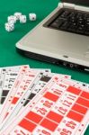 Bingo Cards On Casino Baize And A Laptop Stock Photo