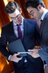 Businessmen With Digital Tablet  In Modern Office Stock Photo