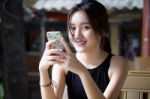 Portrait Of Thai Adult Student University Beautiful Girl Using Her Smart Phone Stock Photo