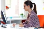 Beautiful Young Woman Using Her Laptop In The Office Stock Photo