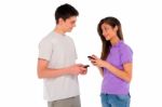 Teenage Couple Holding Smartphone Stock Photo