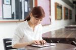 Portrait Of Thai Adult Businesswoman Beautiful Girl Using Her Tablet Stock Photo