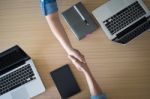 Two Businesspeople Shaking Hands Indoors Stock Photo