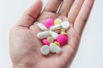 Top View Of The Pills On The Hand And White Background, A Hand Hold The Pills And Drug Stock Photo