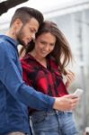 Young Couple Using Smart Phone Stock Photo