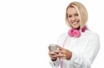 Happy Woman With Cell Phone And Headset Stock Photo