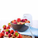 Bran Flakes With Fresh Raspberries And Strawberries And Pitcher Stock Photo