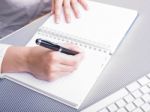 Female Writing On Notebook Stock Photo