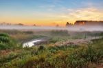 Foggy Summer Meadow In The Morning. Misty Dawn Panorama Stock Photo