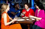 Young Couples Enjoying Their Dinner With Drinks Stock Photo