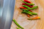 Chili And Knife On Wood Stock Photo