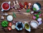 The Ingredients For Homemade Pizza On Shabby Wooden Background Stock Photo