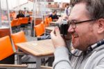 Young Man Traveler Shooting A Vintage Camera Stock Photo