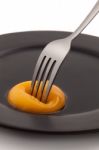 Egg Yolk With Fork Pricking Stock Photo