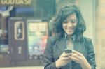 Young Woman With Cell Phone Walking Stock Photo