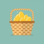 Golden Eggs In Wicker Basket Stock Photo