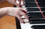 A Woman With Red Ring Playing Piano Stock Photo