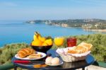 Table With Food And Drinks In Front Of Sea On Island Stock Photo