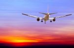 Commercial Airplane Flying At Sunset Stock Photo