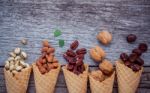 Concept For Homemade Various Nuts Ice Cream. Mixed Nuts In Waffl Stock Photo