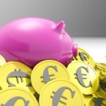 Piggybank Surrounded In Coins Shows European Economy Stock Photo