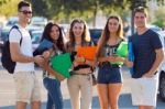 A Group Of Friends Talking In The Street After Class Stock Photo