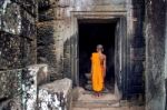 The Monks In The Ancient Stone Faces Of Bayon Temple, Angkor Wat, Siam Reap, Cambodia Stock Photo