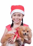 Asian Child In Santa Hat With Dog Stock Photo