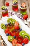 Red And Green Jelly Served With Fruit Stock Photo