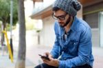 Modern Young Man With Mobile Phone In The Street Stock Photo