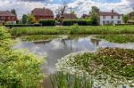 Row Of Houses Overlooking The Pond At Matfield Kent Stock Photo