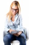 Beautiful Young Woman Sitting At Home With Digital Tablet Stock Photo