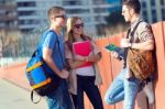 A Group Of Friends Talking In The Street After Class Stock Photo